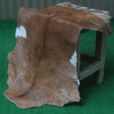 Elegant Brown and White Goat Hide Rug - Perfect Accent for Living Room or Bedroom