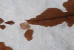 Handcrafted Brown and White Goat Skin Rug - Soft, Durable, and Elegant Décor