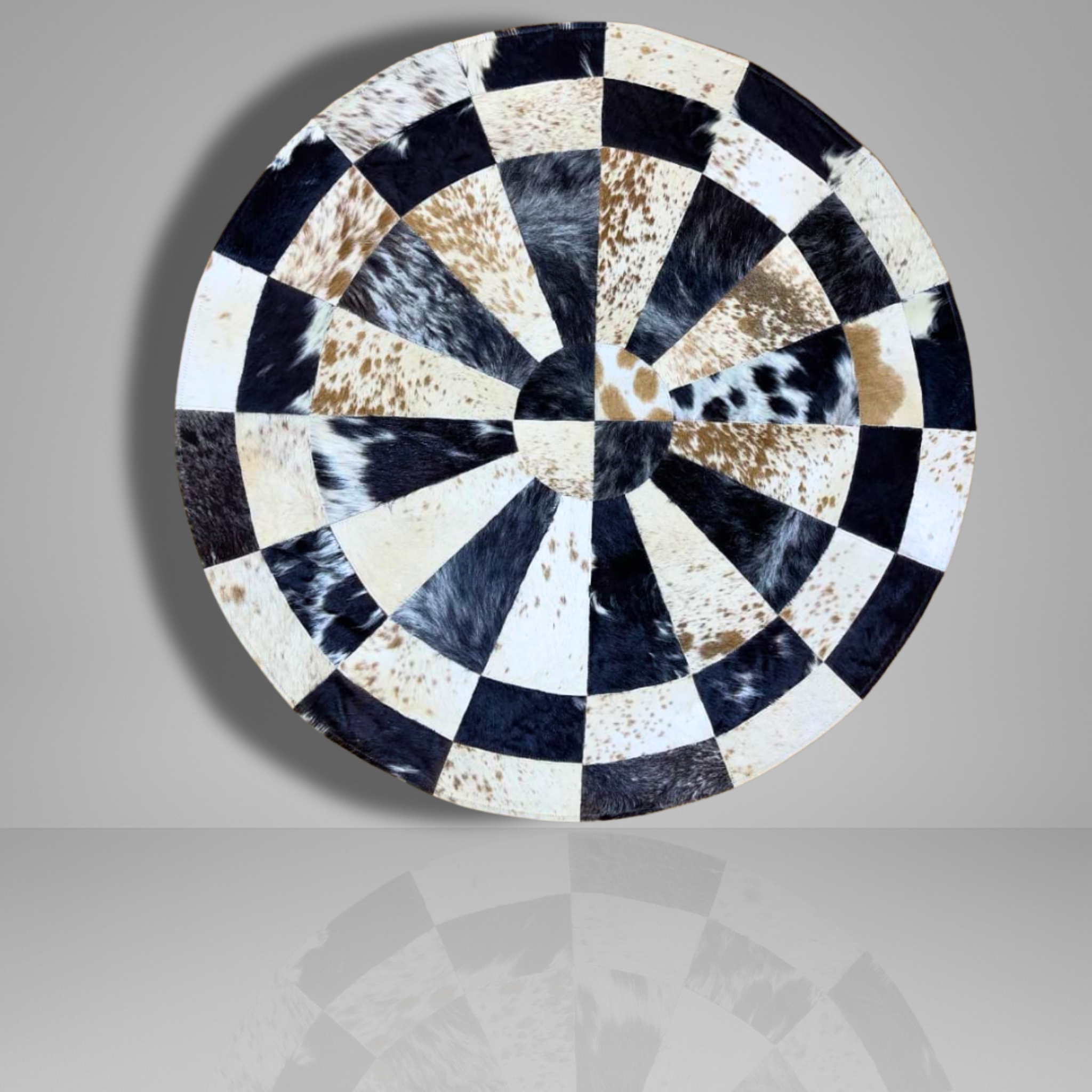 Round decorative plate with black, white, and brown pattern on a gray background