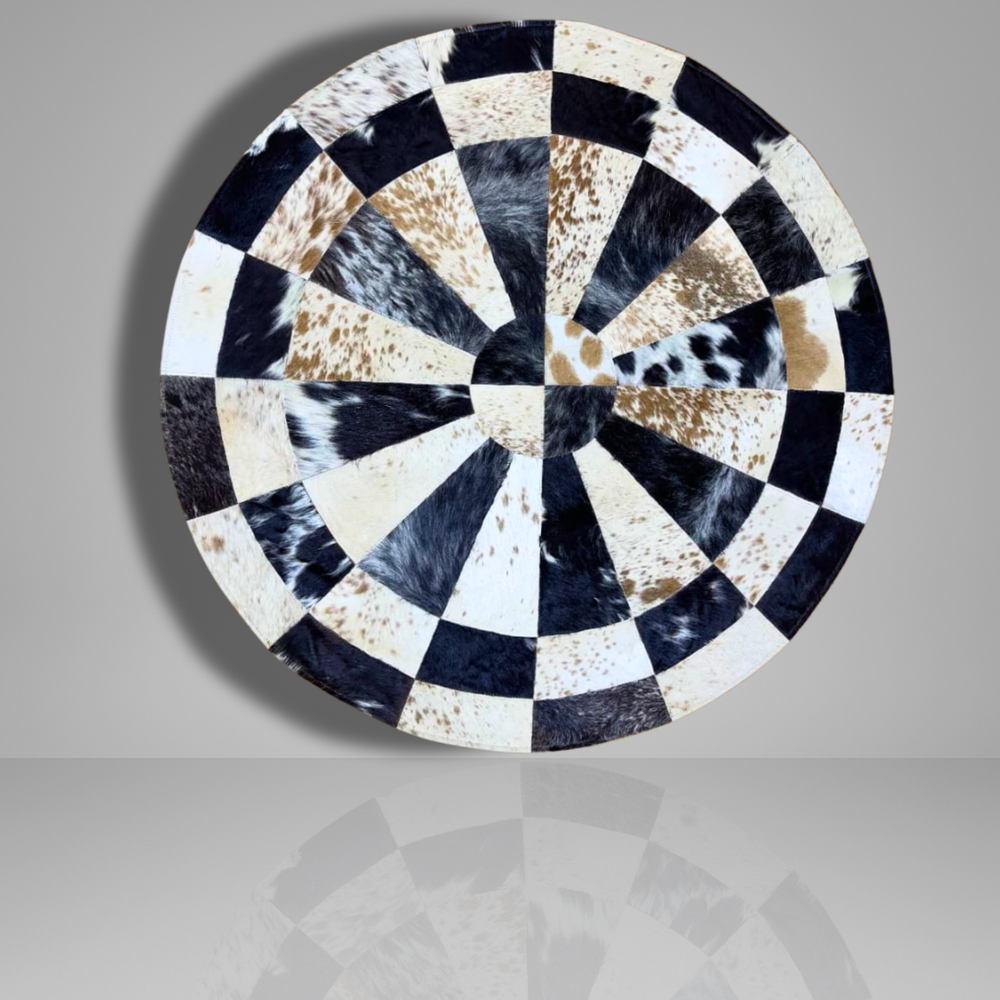 Round decorative plate with black, white, and brown pattern on a gray background