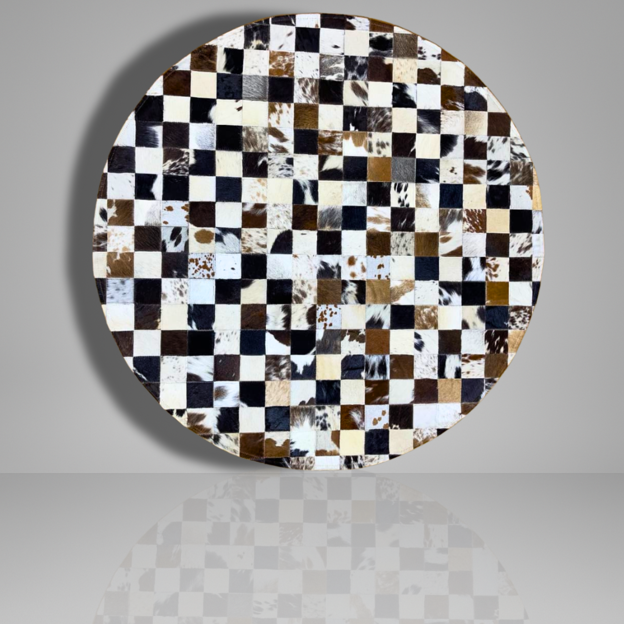 Round table top with a checkered pattern of cowhide leather on a gray background
