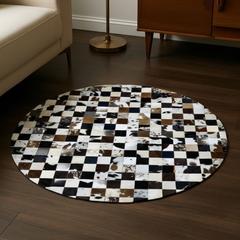 Round checkered rug with animal print pattern on a wooden floor.