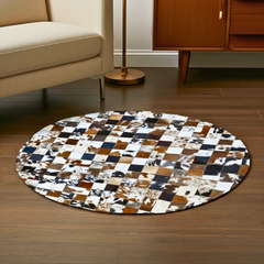 Round patchwork rug on a wooden floor with a beige sofa and wooden cabinet in the background.