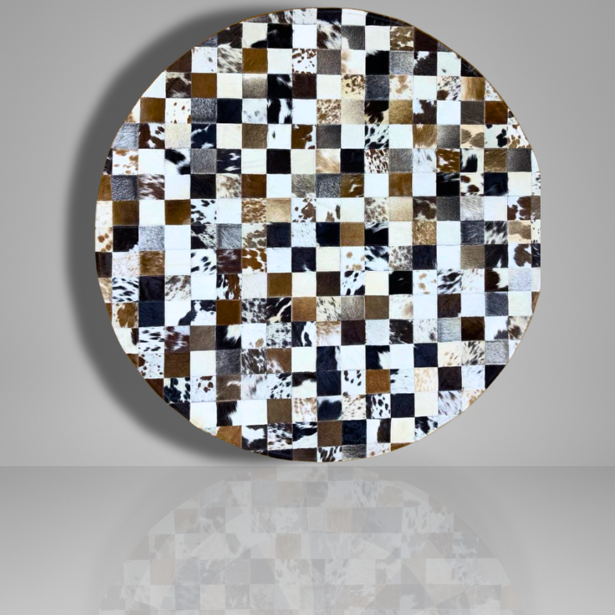 Round table top with a checkered pattern of cowhide leather squares on a gray background