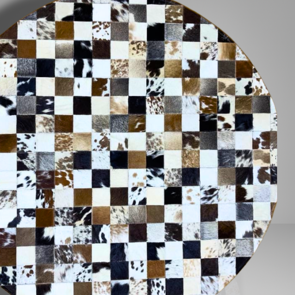 Round surface with a checkered pattern of cowhide leather squares on a gray background