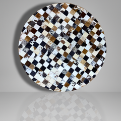 Round table top with a checkered pattern of brown, black, and white on a gray background