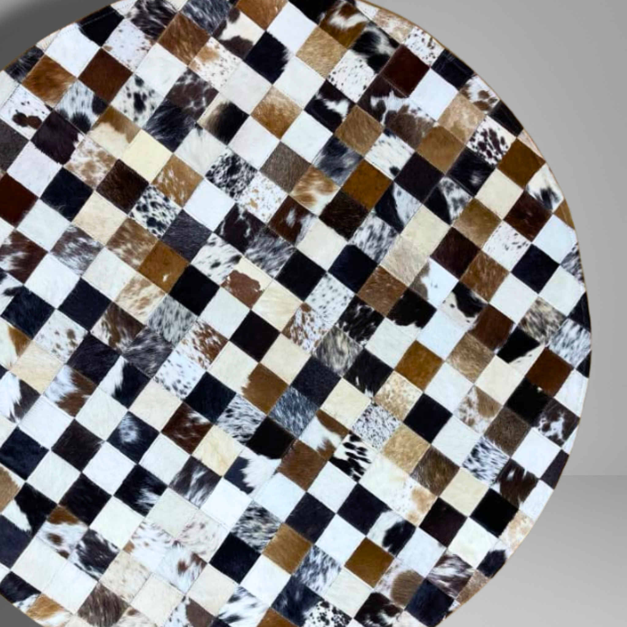 Checkered patterned surface with brown, black, and white colors on a gray background