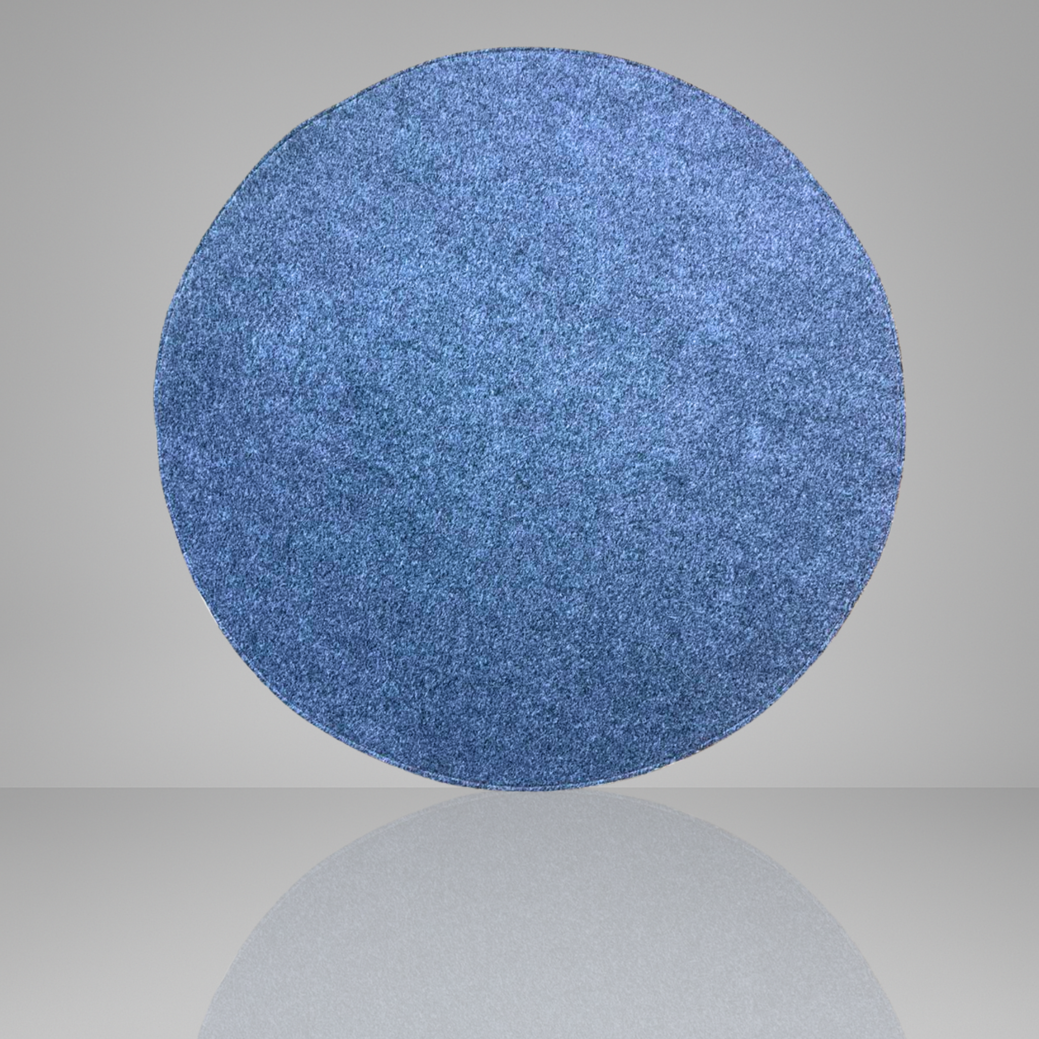 Blue textured circular object on a gray background