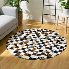 Round checkered rug on a wooden floor with a white sofa and plants in the background
