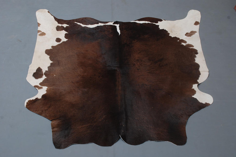 Luxurious Dark Brown & White Cowhide Rug | Medium Size | Hypoallergenic - Durable | Handcrafted Beauty for Rustic Charm - Celestial Leather Limited